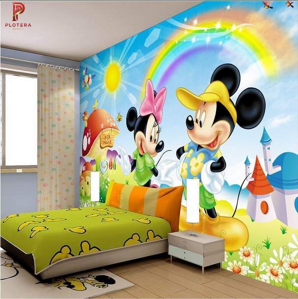 A vibrant kids room wallpaper mural featuring Mickey and Minnie Mouse under a bright rainbow and sun. The playful bedroom setup includes a green bedspread and whimsical castle and mushroom illustrations