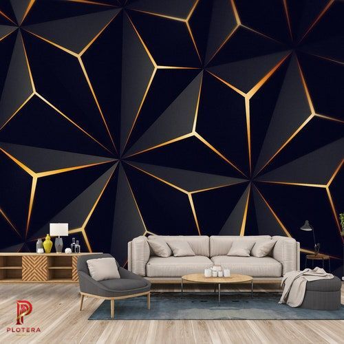 A modern living room featuring a striking geometrical wallpaper with a 3D-effect black triangular pattern accented by glowing gold lines. The bold feature wall creates a high-end, contemporary backdrop for a neutral sofa and minimalist wooden furniture.