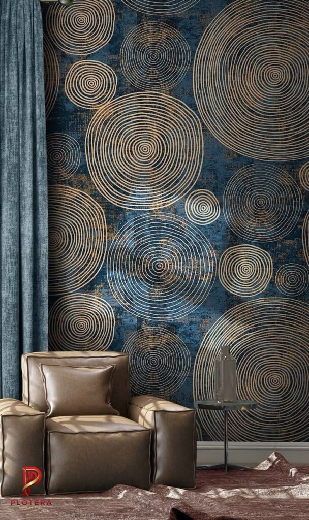 A sophisticated interior space showcasing a navy blue geometrical wallpaper layered with shimmering gold concentric circle patterns in varying sizes. The artistic, textured design adds a luxurious and rhythmic focal point behind a plush leather armchair.